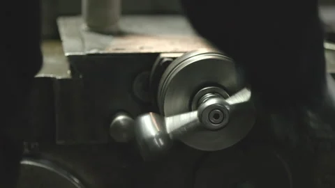 A turner processes a detail on a lathe Stock Footage 233071388