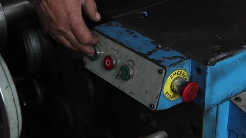 The turner's hand presses the buttons of the machine, turns on the lathe 스톡 동영상 124576518