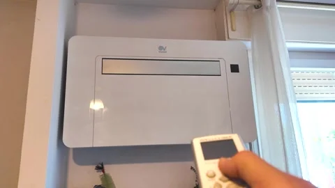 Turning on the air conditioner with the remote control Stock Footage 280051074