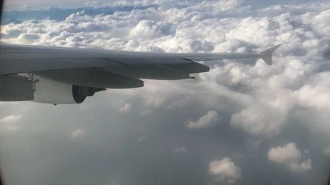 Turning Airplane window view with clouds, Switzerland, Europe. 4K Stock Footage 197701090