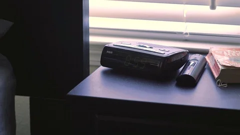 Turning off alarm clock as it strikes 9 am close up Stock Footage 97676653