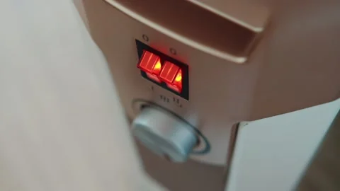 Turning on and adjusting the temperature on the electric heater panel, close-up Stock-Footage 253466686