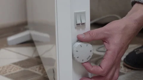 Turning on and adjusting the temperature of the heater Video stock 259887982