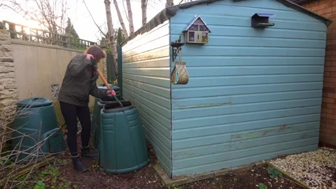 Turning and mixing the compost Stock Footage 321471238