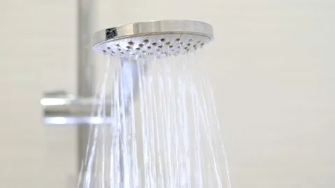 Turning on and off shower head in bathroom, water flow in front of camera Stock Footage