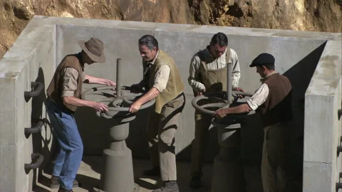 Turning aqueduct valves to activate it, 1904 - Reenactment Stock Footage 202899827