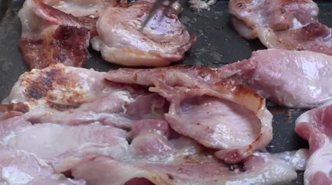 Turning Bacon on grill close up Stock Footage 27381487