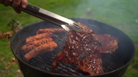 Turning the bbq meat Stock Footage 158183764