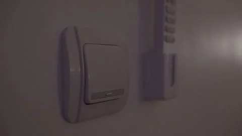 Turning a bedroom light switch on and off Stock Footage 339197144
