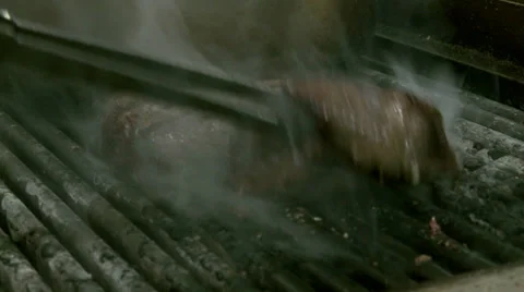 Turning Beef On The Grill Stock Footage 32013539
