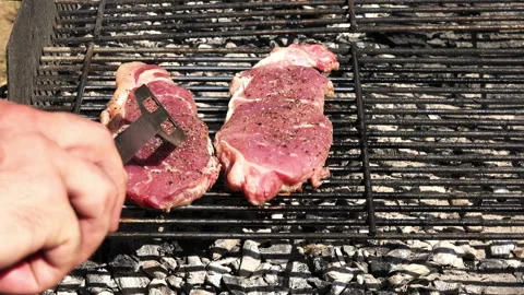 Turning a beef steak 4K Stock Footage 130808591