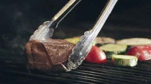 Turning beef steak on the fire grill Video stock 70738849