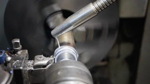 Turning bench lathe machine working casting metal shavings and smoke Video stock 126020925