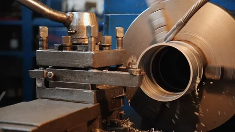 Turning bench lathe machine working with cooling liquid flowing Stock Footage 126225519
