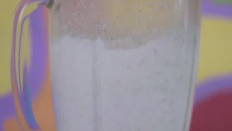 Turning on blender with white liquid inside Stock Footage 79537584