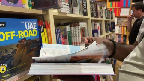 Turning book pages in library  Stock Footage 243063094