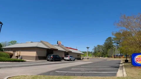 Turning in to Burger King restaurant clear blue sky Washington Road Stock Footage 174385274