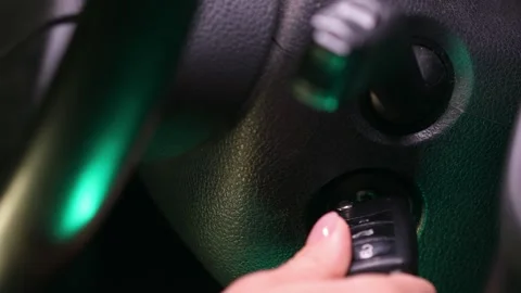 Turning off the car engine. Female hand Turns and pulls out the key Stock Footage 244003870