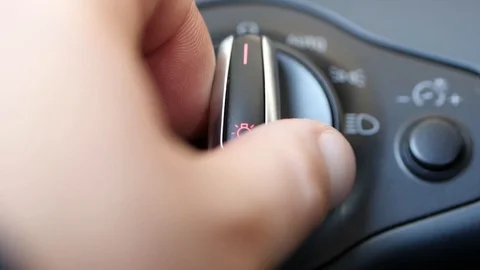 Turning on car headlights Stock Footage 88411149