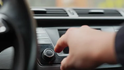 Turning on car stereo, hand adjusting volume level, handheld, close-up Stock Footage 198006522