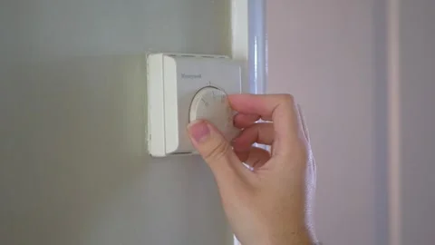 Turning Up Central Heating Thermostat Stock Footage 303660948