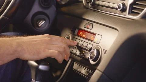Turning on the climate control in the car. Adjusting car air conditioning Stock Footage 256817994