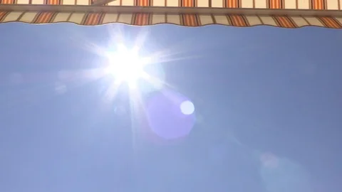 Turning colored striped automatic Sunblind up (Awning up discovering Sun) Video stock 75977329