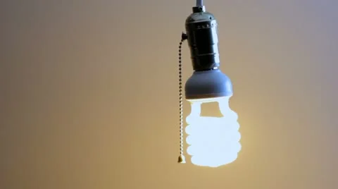 Turning off a compact florescent bulb Stock Footage 21944484