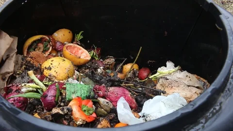 Turning compost pile, steam rises from decaying food Stock Footage 104987437