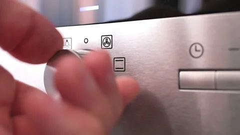 Turning cooking mode switch on an electric oven. Male hand turns on the oven Stockbeeldmateriaal 204900343