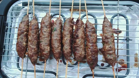 Turning cutlets on an electric grill Видео 252188597