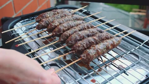 Turning cutlets on an electric grill Stock Footage 252522648