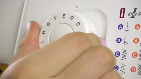 Turning the dial to select patterns on the sewing machine. Stock-Footage 139148269