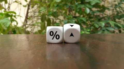 Turning a dice and changes the direction of an arrow symbolizing that the int Stock Photos