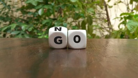 Turning dice and changes the word go to no Stock Photos