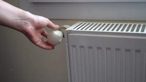Turning down the heating adjusting radiator valve in a room Stock Footage 226376706