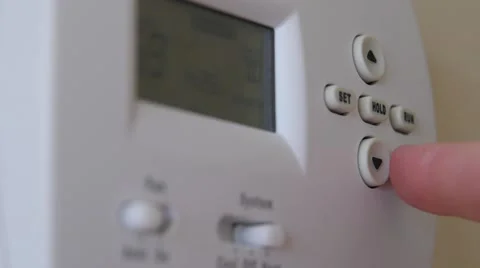 Turning down the temperature on a thermostat Stock Footage 46573631