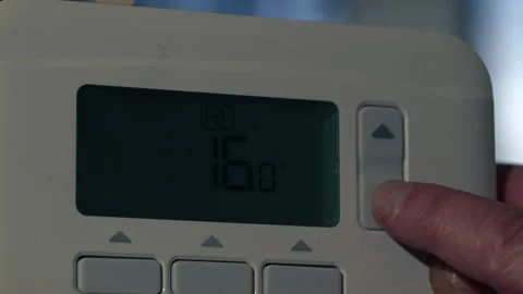 Turning down thermostat on central heating controls Video stock 260693501