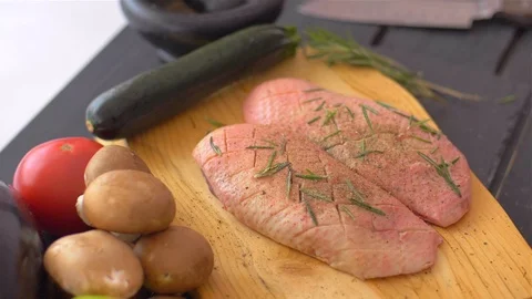 Turning the duck breasts with the skin down. Sprinkle with dry spices Stock Footage 110038694
