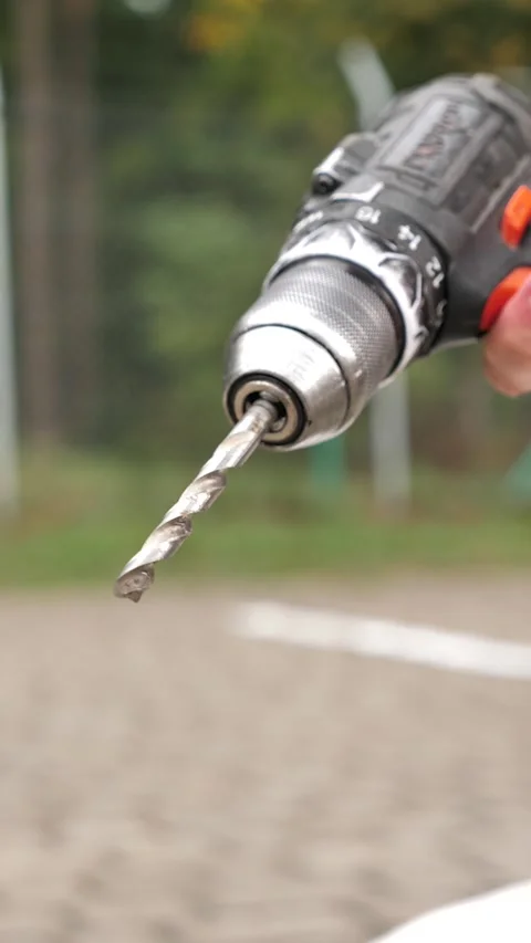 Turning on the electric drill, close-up of turning on the electric drill Stock Footage 252138853