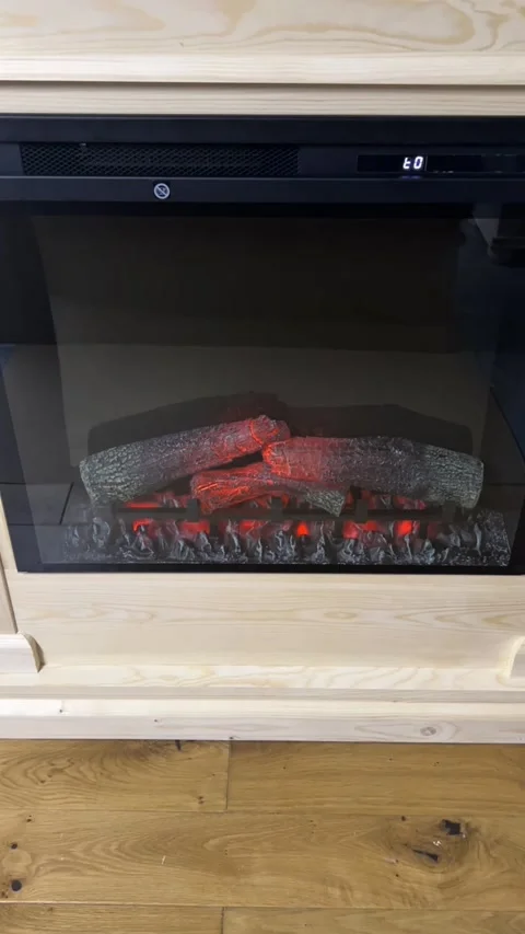 Turning on electric fireplace with remote control turning flame on vertical Stock Footage 341973351