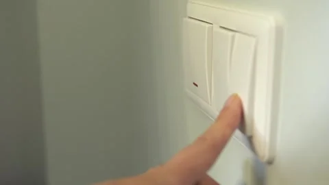 Turning electric lighting on and off in a room. Pressing a wall switch. Stock Footage 342785655