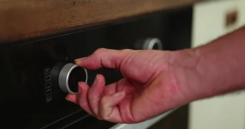 Turning on electric oven Stock Footage 248629932
