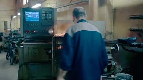 Turning engineer stands behind an automatic drilling machine. Stock Footage 152254260