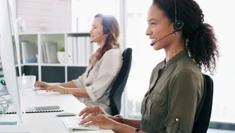 Turning every query into a workable solution. a young woman using a computer and Stock Photos