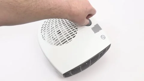 Turning off a fan heater Stock Footage 235177005
