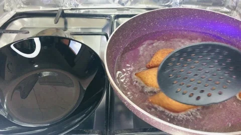 Turning fried Kubbeh in a frying pan Stock Footage 166404549