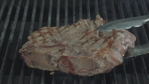 Turning the frying beef steak Stock Footage 92179087