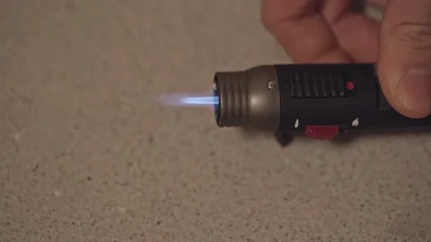 Turning gas lighter torch on with blue flame Stock Footage 218360049