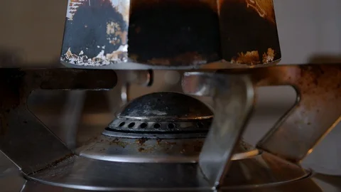 Turning on gas of stove while coffee pot are on top of stove. close up. natural  Stock Footage 128239350